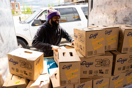 A student loads a truck with food at University of North Texas at Dallas