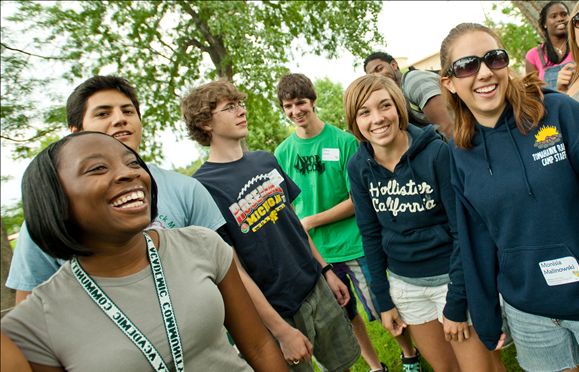 A group of diverse students talking and smiling at Colorado State University.